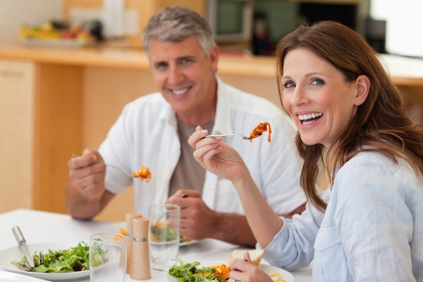 Laughing couple eating dinner